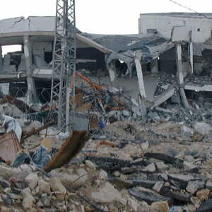 Rubble and destruction dominate a collapsed building site.
